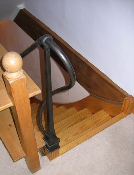 Cottage staircase with forged handrail